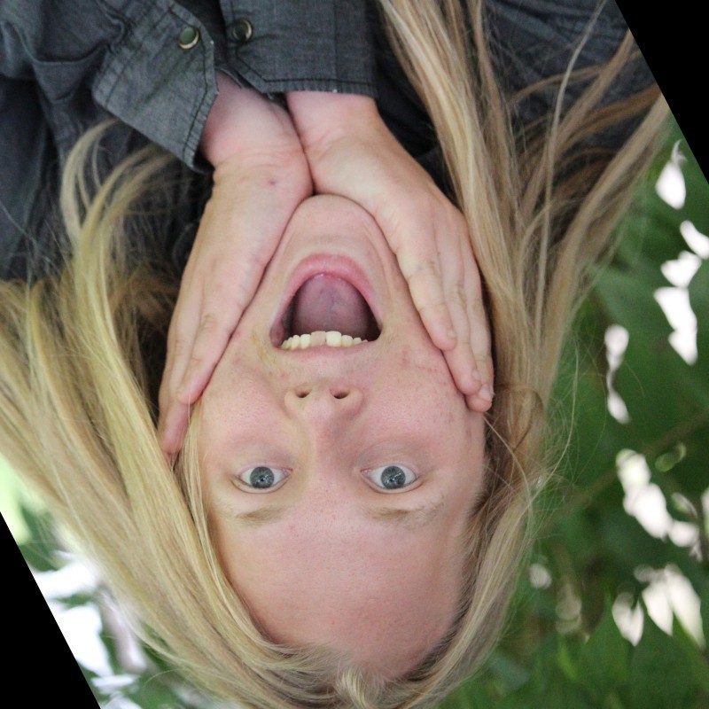 Enoch Bradshaw hanging upside down and making a face